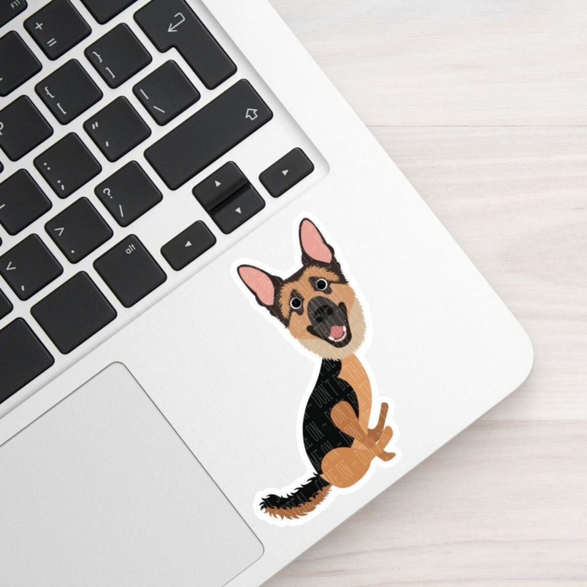 german shepherd draggin booty vinyl sticker featured on a laptop