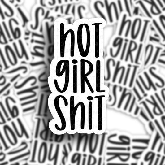 sticker pile of a vinyl adhesive sticker that has the phrase hot girl shit in black letters.